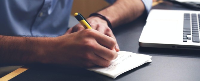 Free Person Writing on Paper Using Yellow and Black Pen Stock Photo