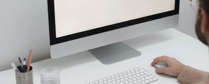 Free Crop man working on computer in workplace Stock Photo