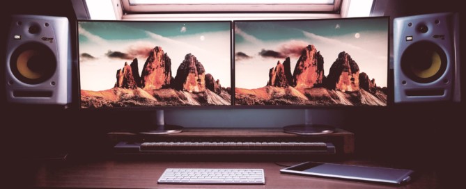 turned on two flat screen computer monitors with speakers