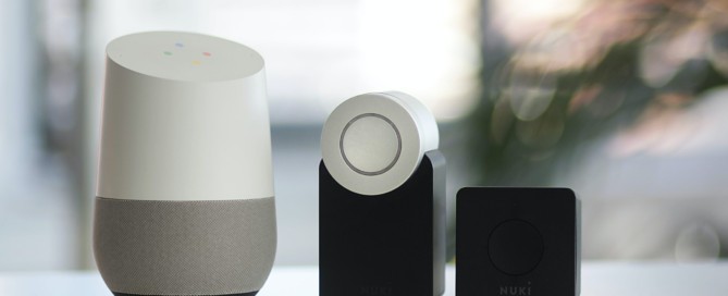 white and gray Google smart speaker and two black speakers