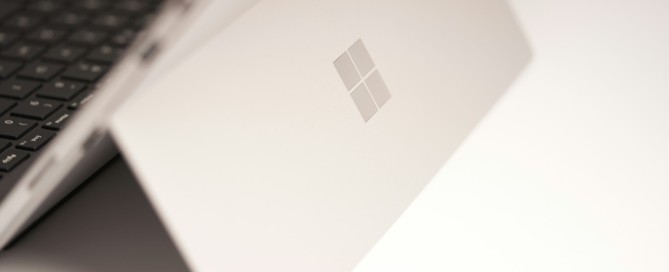 white laptop computer on white table