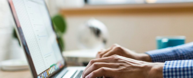 person typing on silver Macbook